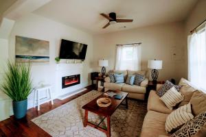 a living room with a couch and a fireplace at Bluewater Downtown Cottage in Wilmington