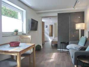 a living room with a couch and a table at Ferienwohnung MH1 "Blue Ocean" in Rostock