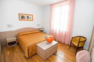 1 dormitorio con 1 cama, 1 mesa y 1 silla en Hotel La Colonna, en Siena