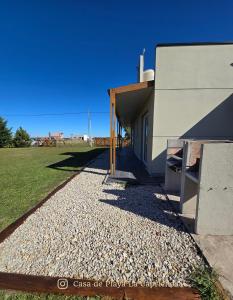 a building with a pebble pathway next to a building at La Caprichosa Chapadmalal in Chapadmalal +9 photos