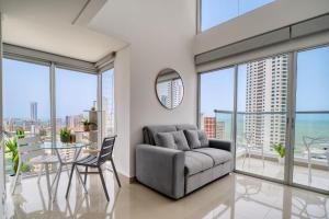 a living room with a couch and a table at Luxury Sea View Duplex in the Heart of the City in Cartagena de Indias