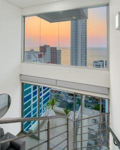 a balcony with a view of the ocean and buildings at Luxury Sea View Duplex in the Heart of the City in Cartagena de Indias +10 photos