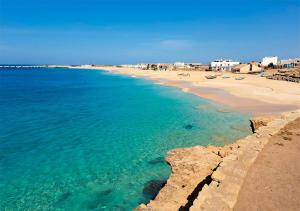 a view of a beach with chairs and the ocean at Villa Baleia Stella Maris Exclusive in Calheta Do Maio