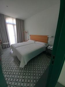 Łóżko lub łóżka w pokoju w obiekcie TORREMOCHA