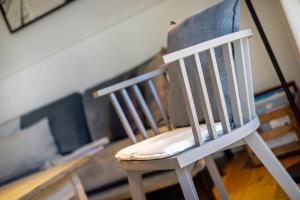 a white chair sitting in a living room at Haus Strandlaeufer in Keitum