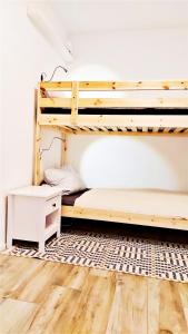 a bedroom with bunk beds and a wooden floor at Ferienhaus Kitzenwiese in Friedrichshafen