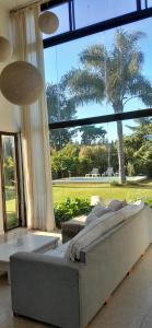 a large bed in a room with a large window at Family House Los Cuatro Robles in San Pedro