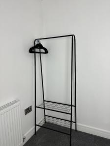 a black iron mirror in front of a white wall at Central Hull Apartments in Hull