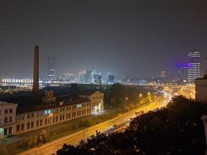 a view of a city at night with buildings and street lights at Sajam in Senjak (historical)