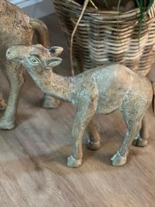 a metal statue of a deer on a table at FeWo Storchennest in Schönberg +12 photos