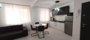 a kitchen with a table and chairs in a room at Apartament Pro Confort in Tulcea +9 photos