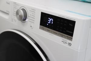 a washing machine with a digital clock on it at Gemütliche Wohnung am Bodensee - Self-CheckIn in Markdorf