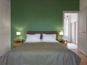 a bedroom with a large bed with green walls at Maison de Charme à la Campagne avec Jardin, Billard, Baby-foot et Terrasse en Teck - FR-1-581-135 in Vitray-sous-Brézolles