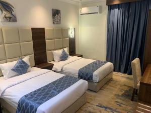 Ένα ή περισσότερα κρεβάτια σε δωμάτιο στο ســكــورد للــشــقـــق الــفنــدقــيـه Scord Hotel Apartments