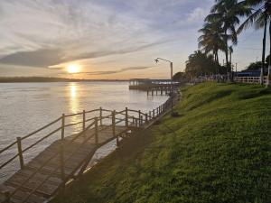 a bridge over a body of water with a sunset at HOTEL E RESTAURANTE ILHA BELA in Soure