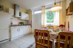a kitchen and dining room with a table and chairs at Ferienhaus an der Baeke A in Bad Zwischenahn +11 photos