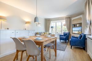a kitchen and dining room with a wooden table and chairs at Durango in Keitum