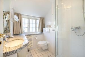 a bathroom with a toilet and a shower and a sink at Durango in Keitum +20 photos