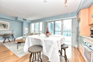 多倫多的住宿－300 Front Suites，厨房以及带桌椅的用餐室。