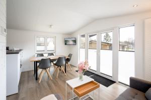 a kitchen and living room with a table and chairs at Ostseecamp Chalet Haffkrug No 59 in Scharbeutz