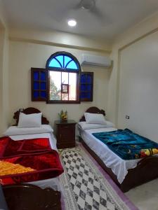 Postel nebo postele na pokoji v ubytování Osiris Guest House