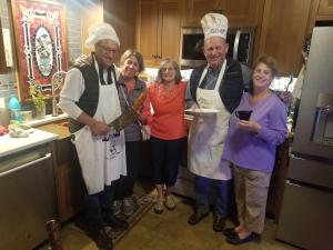 a group of people in a kitchen posing for a picture at The Queen, A Victorian Bed & Breakfast in Bellefonte