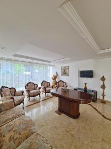 a large living room with couches and a coffee table at Fora Apart Otel Cesme in Çeşme
