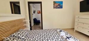 a bedroom with a bed and a dresser and a mirror at Bella Sorella View in Pizzo +16 photos