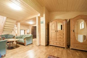 a living room with wooden walls and a table and chairs at Drevenica Rybárie in Klokočov