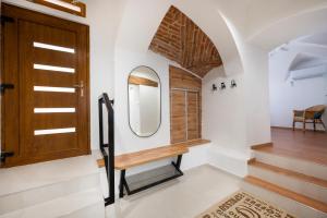 a hallway with a mirror and a wooden door at Romantic-Fireplace-Centrum-Bathtub in Kőszeg