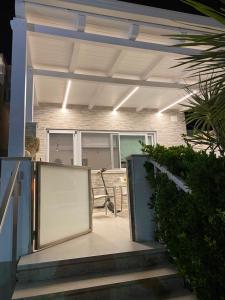a garage with a door open on the stairs at Villa con piscina L’Approdo in Barletta