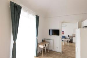 a living room with a table and a large window at Sofia's Central Apartment Palermo in Palermo