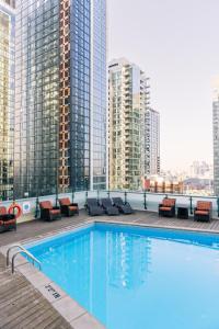 a swimming pool on the roof of a building with tall buildings at Hyatt Regency Toronto in Toronto