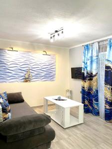 a living room with a couch and a table at Sea breeze 2 in Limenaria