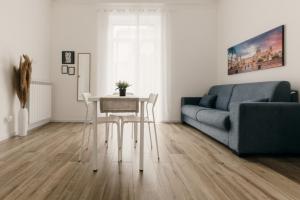 a living room with a table and a couch at Sofia's Central Apartment Palermo in Palermo