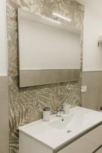 a bathroom with a sink and a mirror at Sofia's Central Apartment Palermo in Palermo