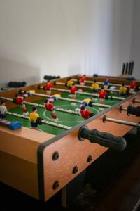 a row of tables with toy people playing billiard at Get Up Hostel in Natal