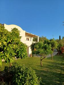 ein weißes Haus mit Bäumen im Hof in der Unterkunft La Casa di Pitti in Anacapri