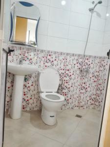 a bathroom with a toilet and a sink and a mirror at One bedroom apartement at Martil 300 m away from the beach with city view and wifi in Martil