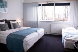 Postel nebo postele na pokoji v ubytování Hotel Strandparken