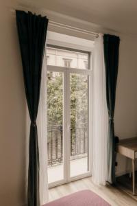 a window with black and white curtains in a room at Sofia's Central Apartment Palermo in Palermo