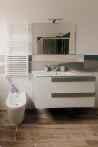 a white bathroom with a sink and a mirror at Sofia's Central Apartment Palermo in Palermo