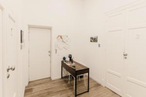 a room with a table and a white wall at Sofia's Central Apartment Palermo in Palermo