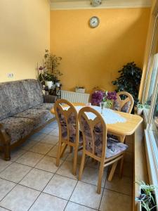 a living room with a table and chairs and a couch at FeWo Anastasija in Niederlauch