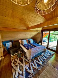a bedroom with a bed and a couch and a rug at Naarden with Sauna in Budapest