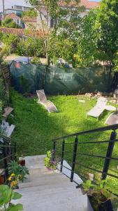 a backyard with a playground with a fence and benches at Maison cosy au calme avec jardin in Agen