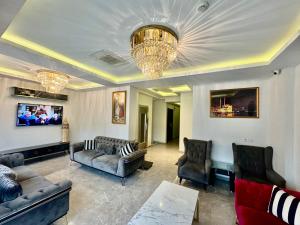 a living room with couches and a chandelier at Aram Edessa Hotel in Istanbul +55 photos