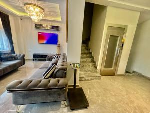 a living room with a leather couch in the middle at Aram Edessa Hotel in Istanbul