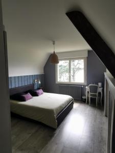 a bedroom with a large bed and a window at Les pieds dans l'eau in Saint Malo