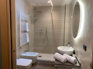a bathroom with a sink and a toilet and a shower at Casa vacanze Clorofilla in Bergamo